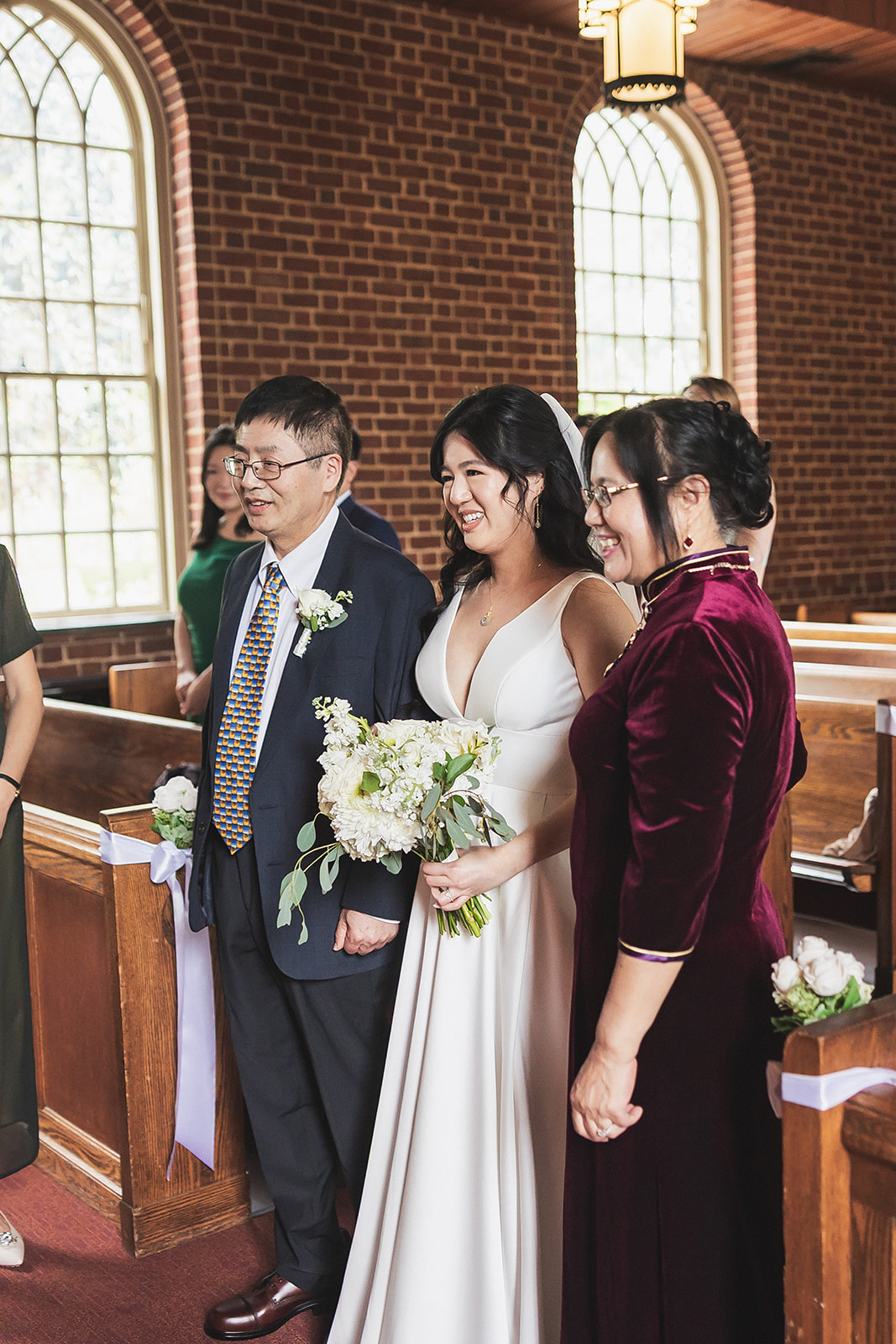 bride walking down aisle with parents at garden chapel UMD