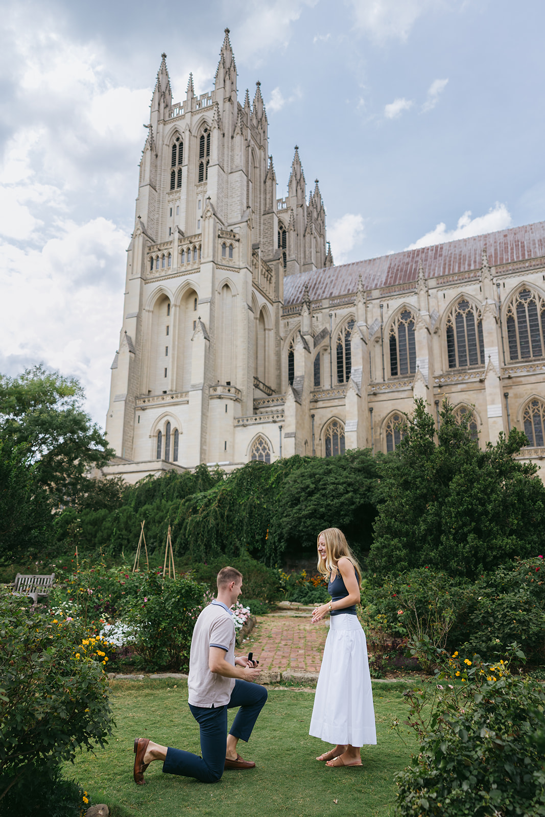 man proposing to his girlfriend in front of the national cathedral in DC