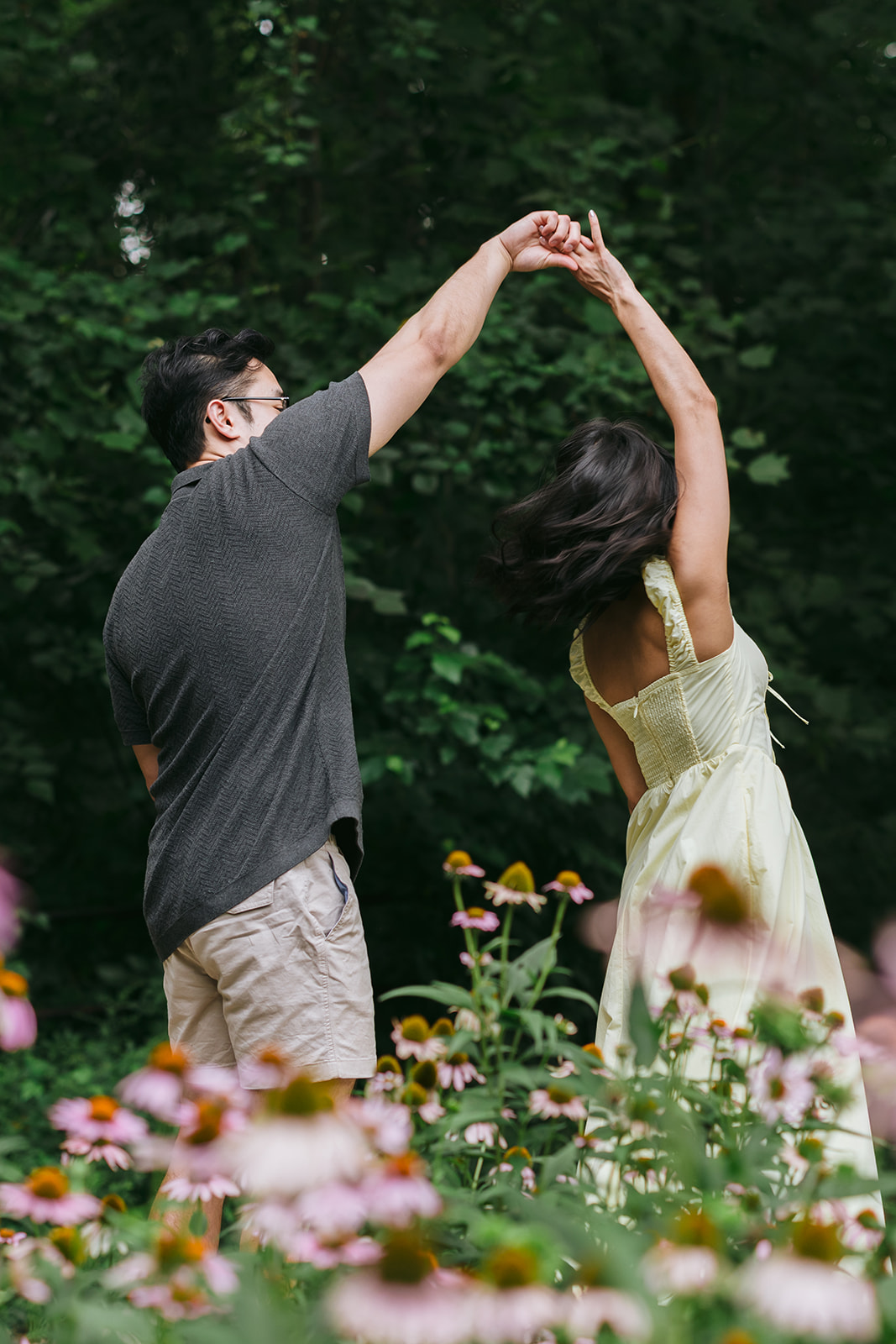 couple dancing in a field of flowers